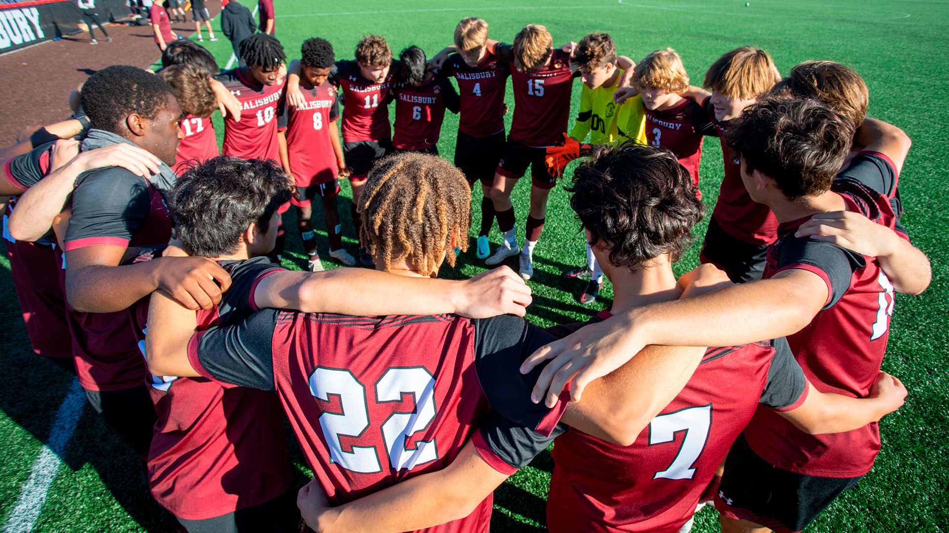 A prep-school team gathers in a huddle