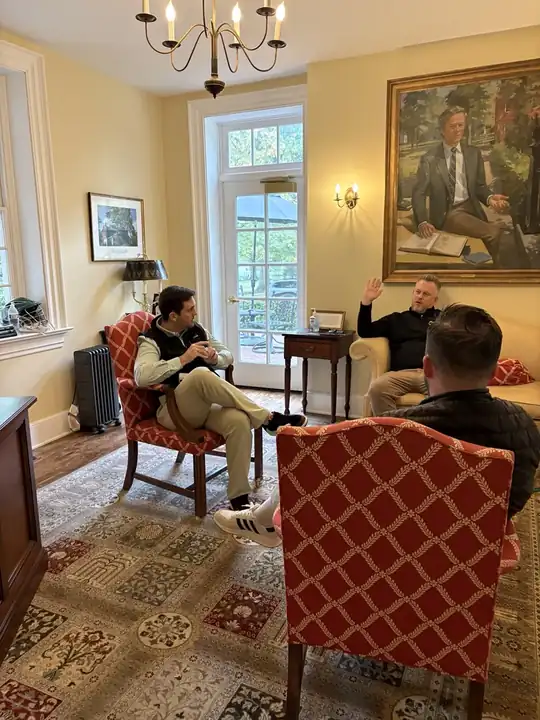 GESP advisor in conversation with boarding school staff in a campus office