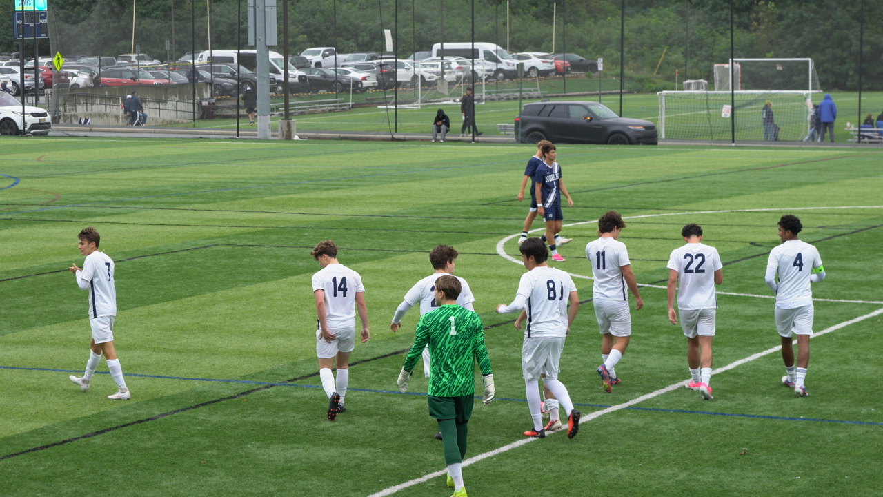 A boys’ soccer team walking back into position during a match