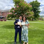 Daniel Argueta Rosales and his mother, Marielos Rosales, holding certificates on a school campus