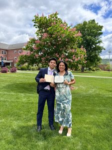 Daniel Argueta Rosales and his mother, Marielos Rosales, holding certificates on a school campus